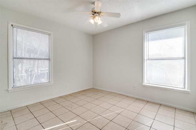 tiled spare room featuring ceiling fan and a textured ceiling