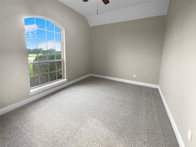 spare room with ceiling fan, lofted ceiling, and carpet flooring