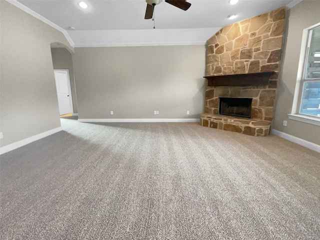 unfurnished living room with lofted ceiling, crown molding, and carpet