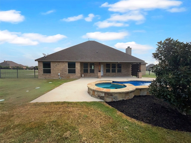 view of swimming pool with a lawn, an in ground hot tub, and a patio area