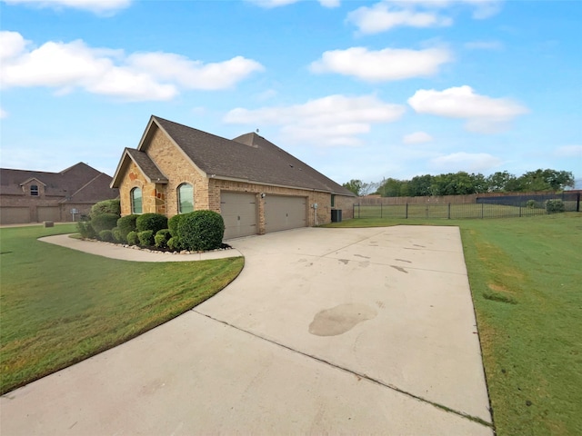 view of side of home featuring a lawn and a garage