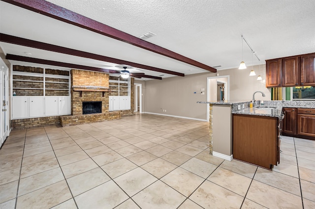 kitchen with light tile patterned floors, built in features, and ceiling fan