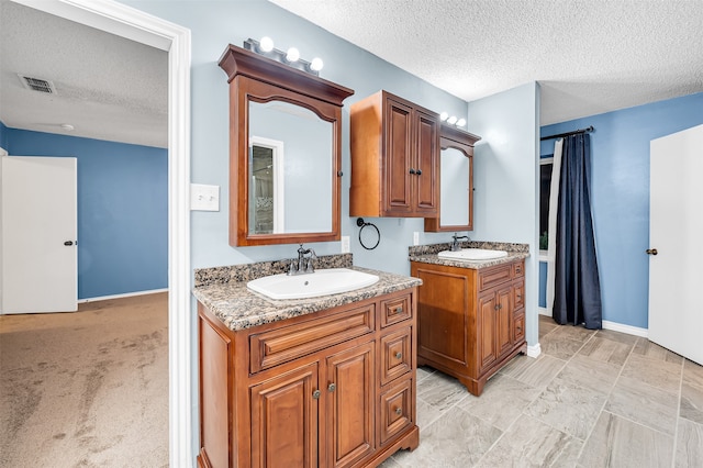 bathroom featuring vanity and a textured ceiling