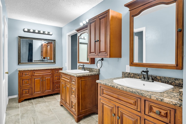 bathroom featuring vanity and a textured ceiling