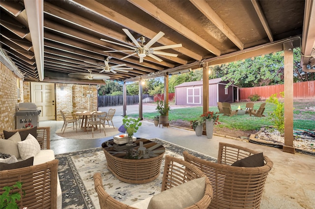 view of patio / terrace featuring a storage unit and a grill