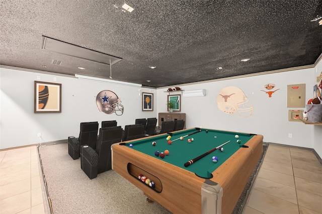 game room with ornamental molding, a textured ceiling, light tile patterned floors, an AC wall unit, and pool table