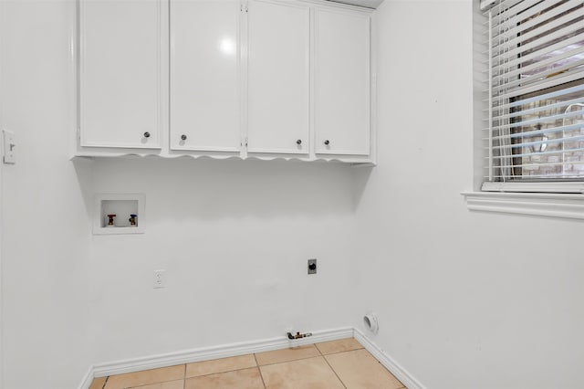 laundry room with cabinets, hookup for a gas dryer, hookup for a washing machine, hookup for an electric dryer, and light tile patterned flooring