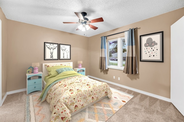 bedroom featuring carpet flooring, a textured ceiling, and ceiling fan