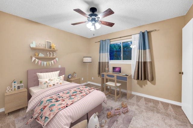 carpeted bedroom featuring ceiling fan and a textured ceiling