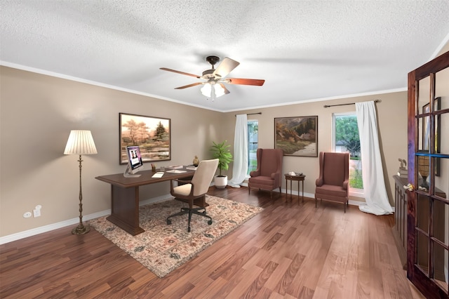 home office with ceiling fan, dark hardwood / wood-style flooring, a textured ceiling, and ornamental molding