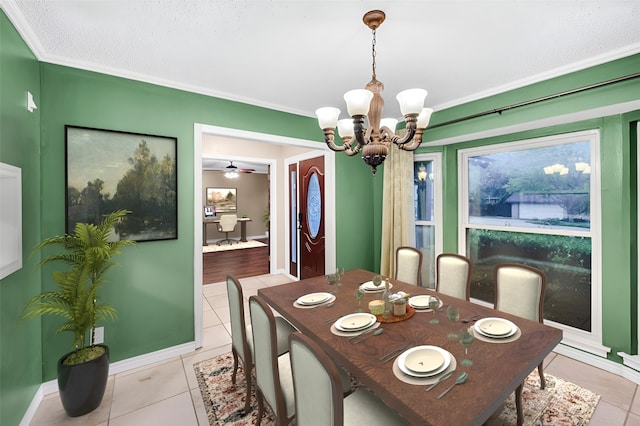 tiled dining room with ceiling fan with notable chandelier and crown molding