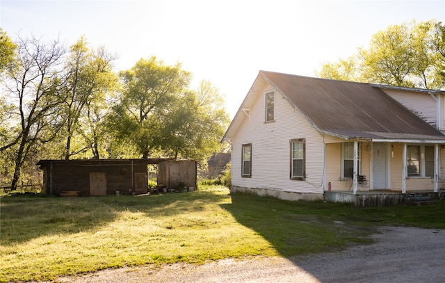 view of property exterior featuring a porch and a lawn