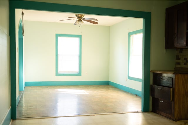 interior space featuring ceiling fan and a wealth of natural light