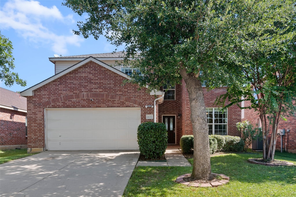 view of front property with a garage and a front yard