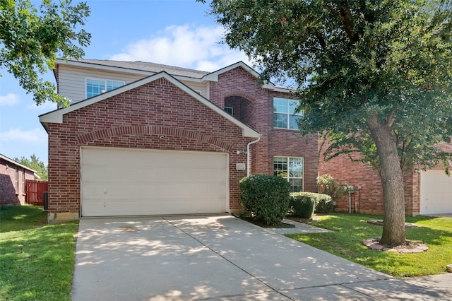 view of front property featuring a front lawn and a garage