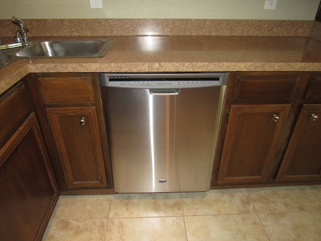 kitchen with dishwasher, light tile patterned floors, and sink