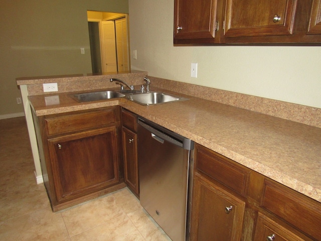 kitchen featuring stainless steel dishwasher, sink, light tile patterned floors, and kitchen peninsula