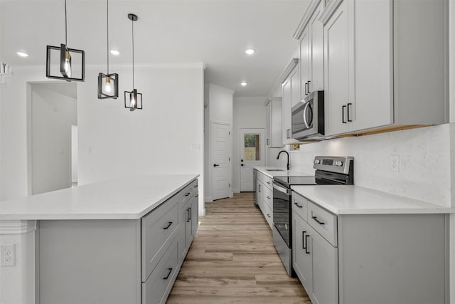 kitchen with appliances with stainless steel finishes, backsplash, light hardwood / wood-style flooring, decorative light fixtures, and ornamental molding