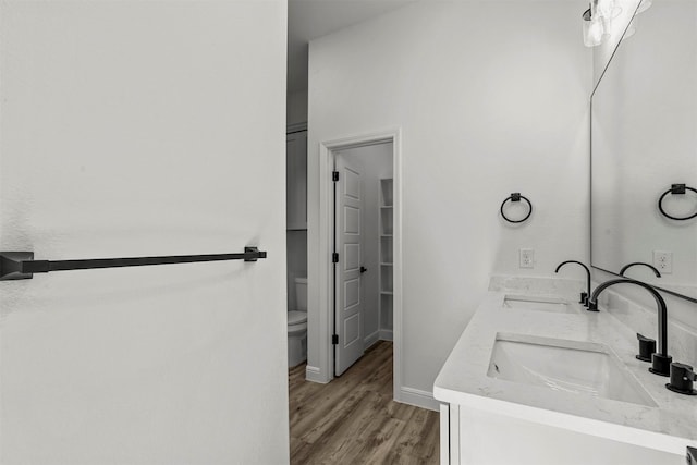 bathroom with vanity, hardwood / wood-style floors, and toilet