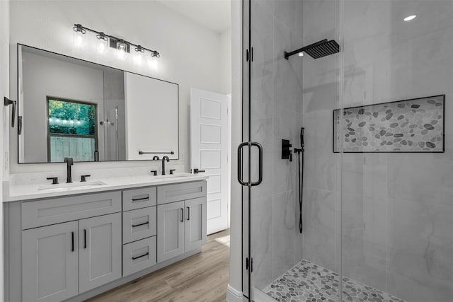 bathroom with vanity, hardwood / wood-style flooring, and an enclosed shower