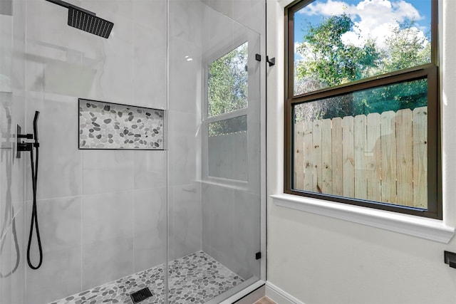 bathroom featuring a shower with door