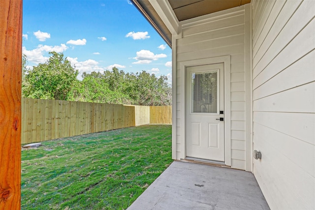 entrance to property with a lawn