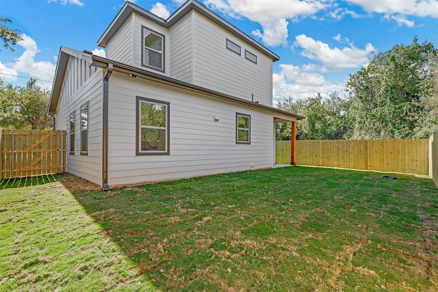 back of house featuring a yard