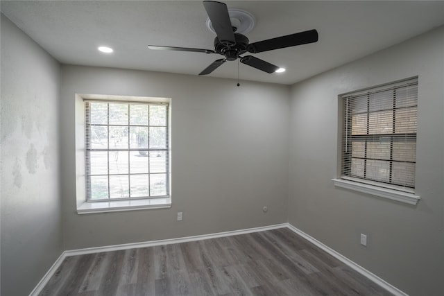 spare room with wood-type flooring and ceiling fan