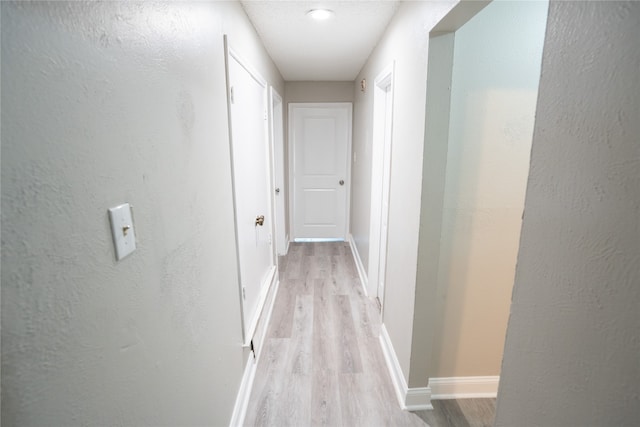 hallway with light hardwood / wood-style flooring