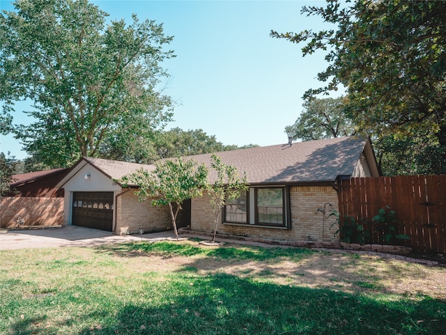 single story home with a front yard and a garage