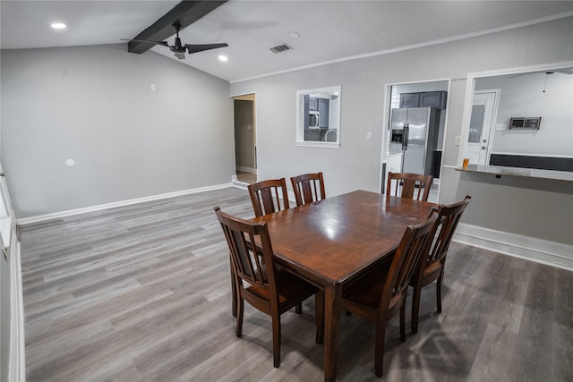 dining room with lofted ceiling with beams, ornamental molding, ceiling fan, and hardwood / wood-style floors