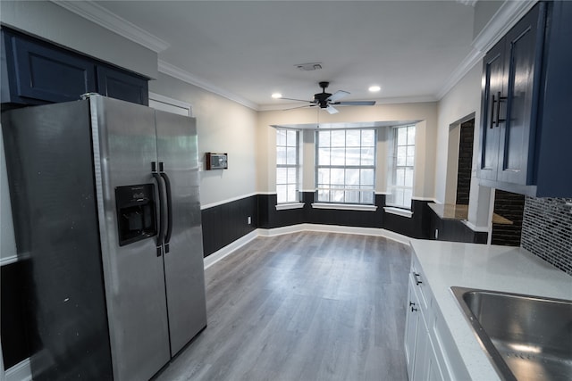 kitchen featuring stainless steel refrigerator with ice dispenser, white cabinetry, light hardwood / wood-style flooring, and ornamental molding