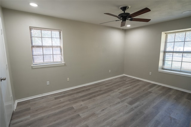 spare room with ceiling fan and dark hardwood / wood-style flooring