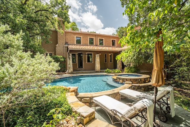 view of swimming pool featuring a patio area and an in ground hot tub