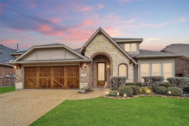 704 Marietta Ln, Aubrey, TX 76227 - view of front facade featuring stone siding, an attached garage, a front yard, driveway, and a shingled roof