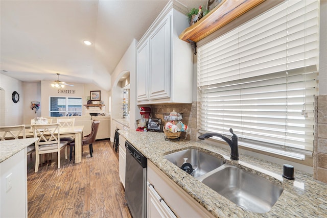 kitchen featuring white cabinetry, dishwasher, light stone countertops, sink, and dark hardwood / wood-style floors