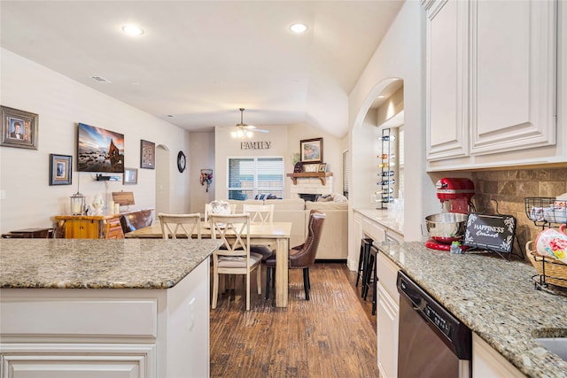 kitchen featuring ceiling fan, dishwasher, light stone counters, dark hardwood / wood-style flooring, and white cabinets