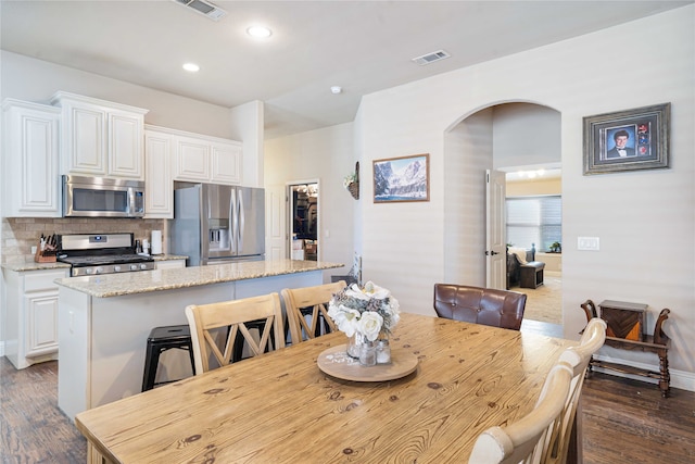 dining space featuring dark hardwood / wood-style flooring