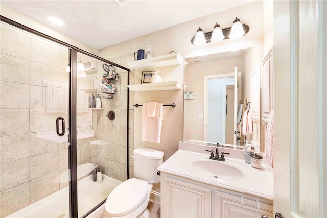 bathroom with vanity, toilet, and walk in shower