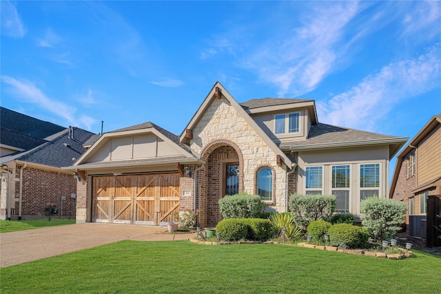 view of front of house with a garage and a front lawn