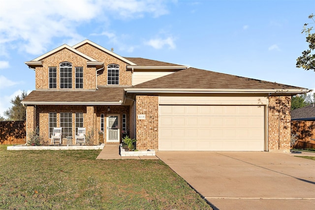 view of front of house with a garage, a front yard, and covered porch