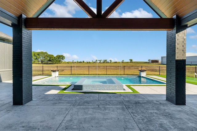 view of pool with pool water feature, a patio, and an in ground hot tub