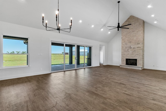 unfurnished living room with a fireplace, dark hardwood / wood-style flooring, high vaulted ceiling, and a wealth of natural light