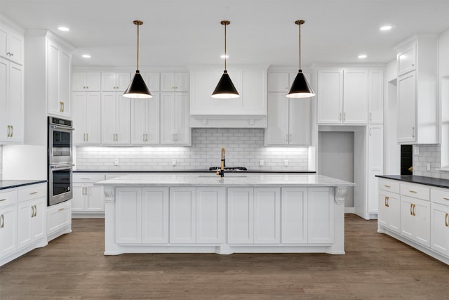 kitchen featuring backsplash, dark hardwood / wood-style floors, and hanging light fixtures