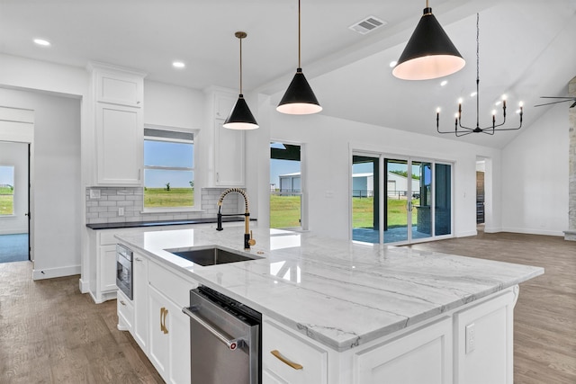 kitchen featuring hanging light fixtures, sink, a center island with sink, white cabinetry, and stainless steel appliances