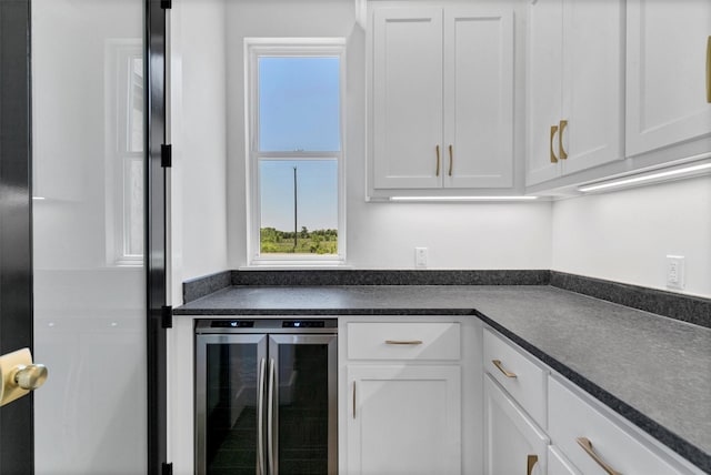 5360 Moncrief Rd, Justin, TX 76247 - kitchen with beverage cooler, white cabinets, and dark countertops