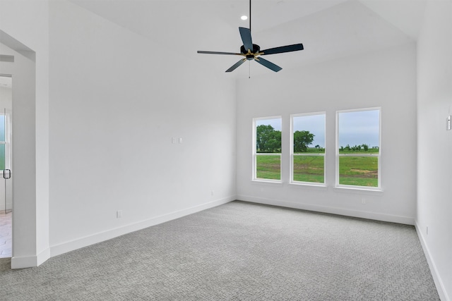 spare room with ceiling fan and light carpet