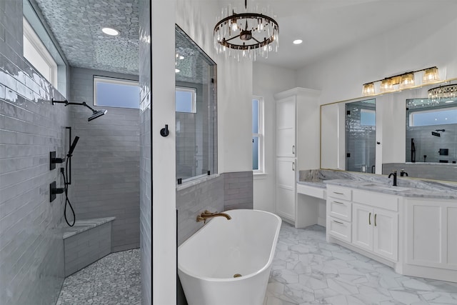 bathroom with vanity, a chandelier, and plus walk in shower