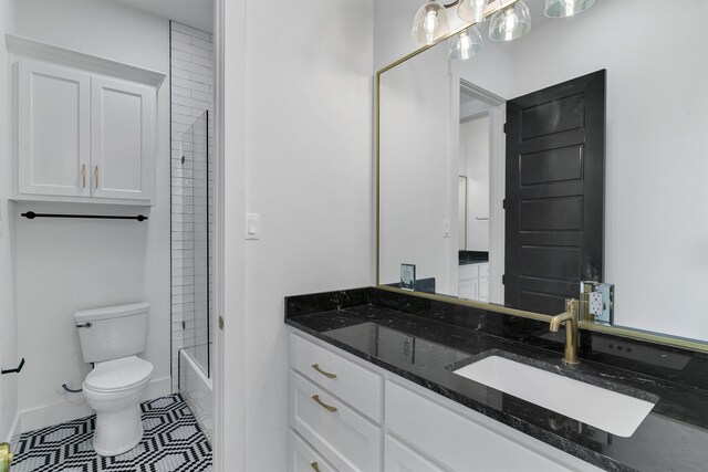 full bathroom featuring vanity, tiled shower / bath combo, toilet, and tile patterned floors