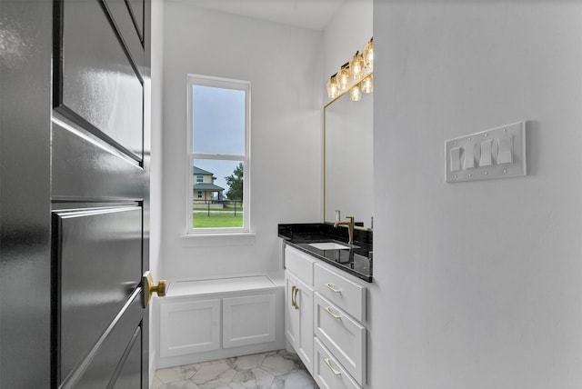 bathroom with a shower with shower door and vanity